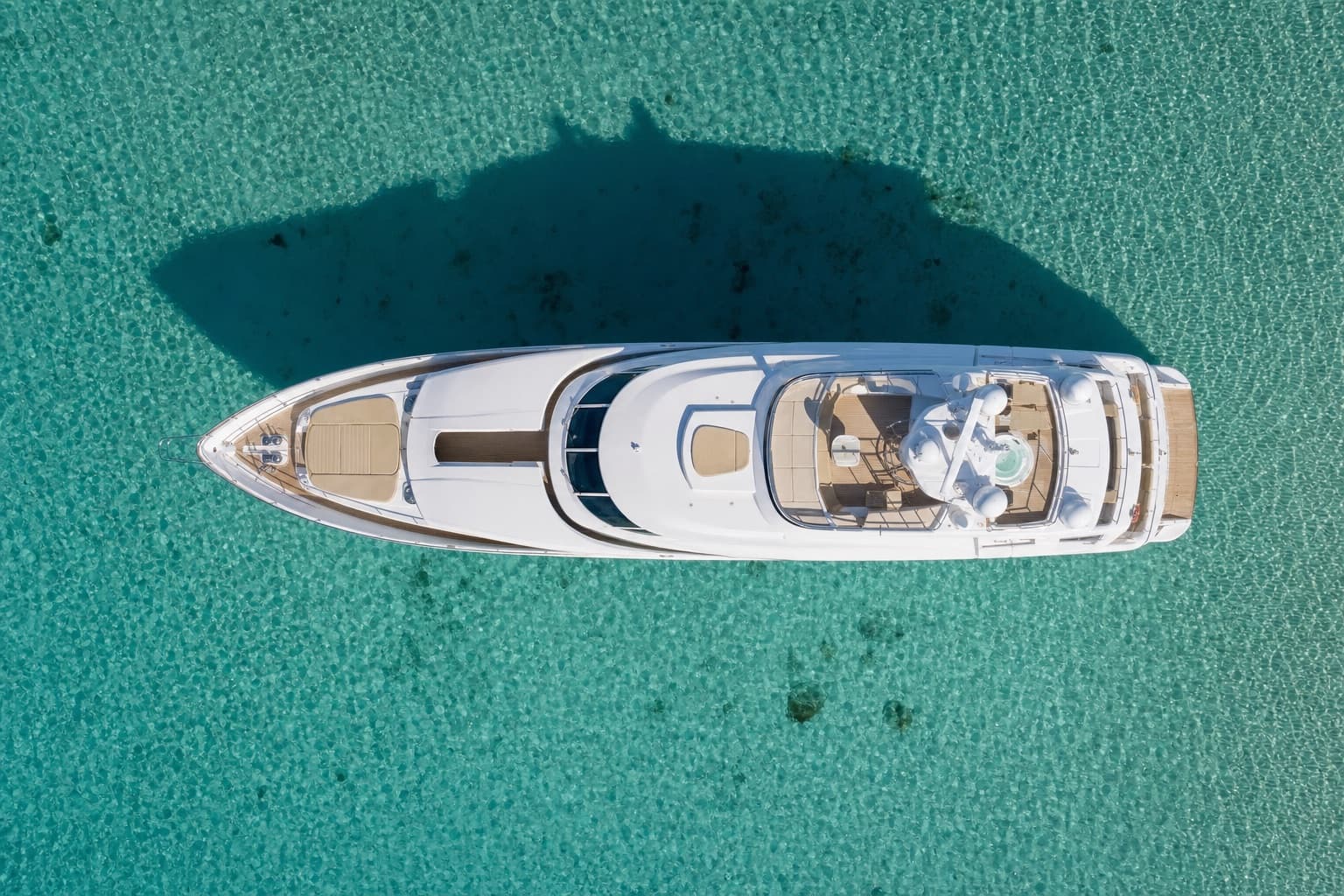 Aerial view of a superyacht on blue water