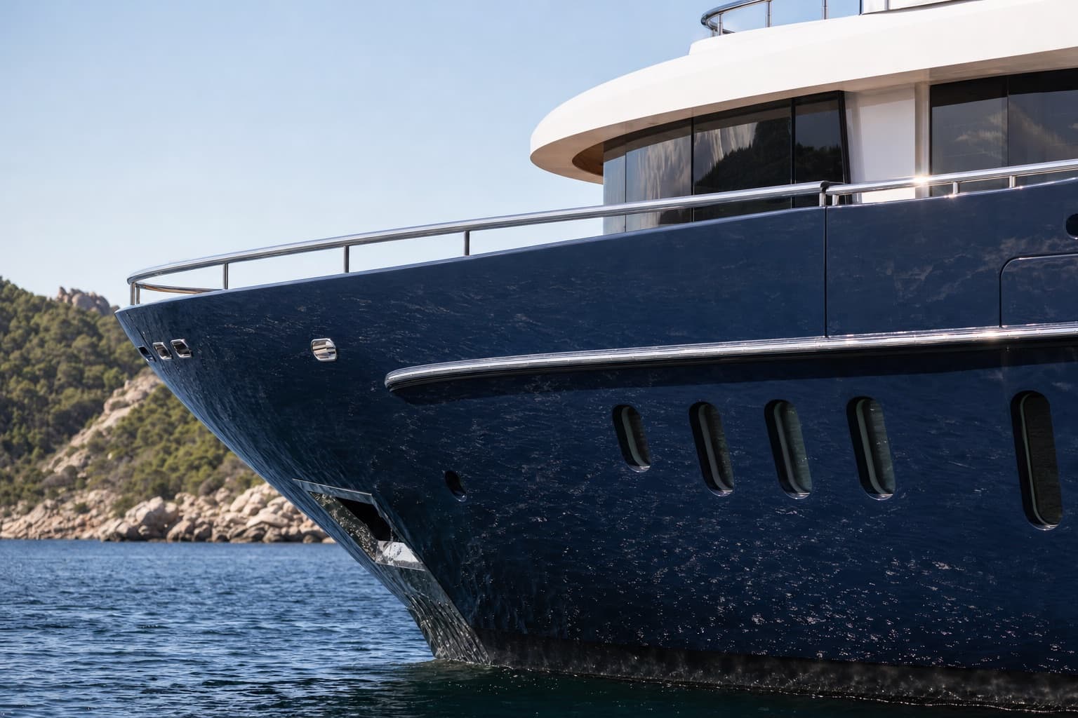 A dark-hulled superyacht up close